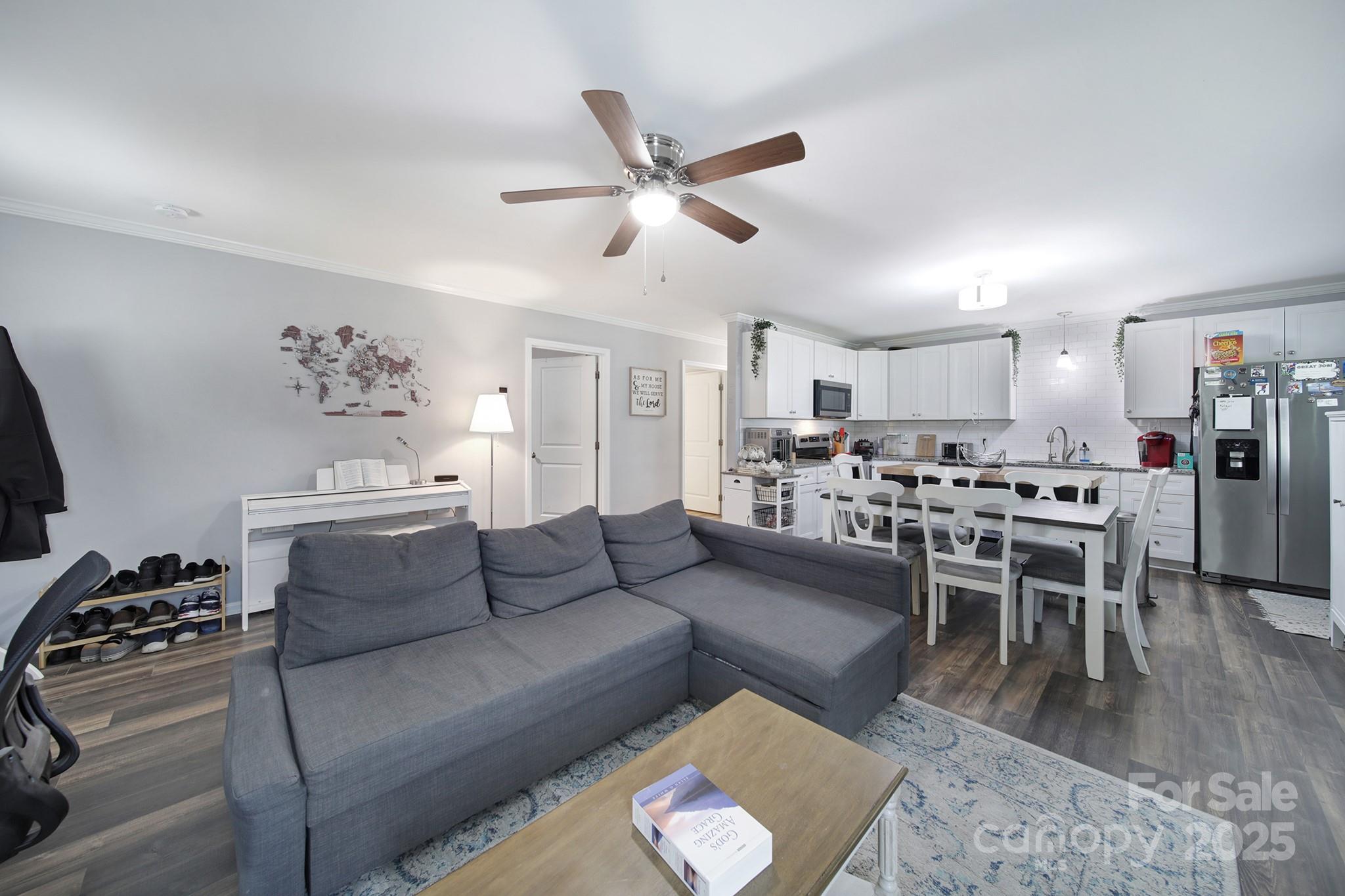 2302 Douglas Road Lancaster, SC 29720 - Photo 9 of 30 a living room with furniture kitchen view and a chandelier