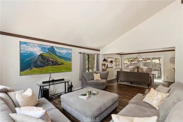 a view of a dining room with furniture a chandelier and wooden floor