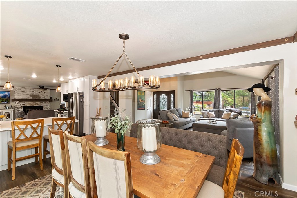 120 Pine Ridge Road Crestline, CA 92325 - Photo 17 of 58 a view of a dining room with furniture a chandelier and wooden floor