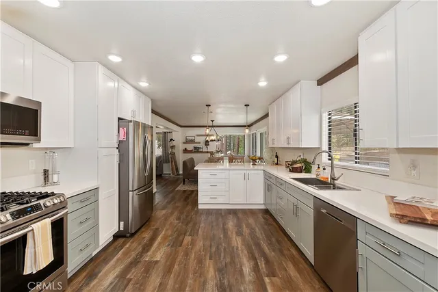 a kitchen with stainless steel appliances a sink stove and cabinets