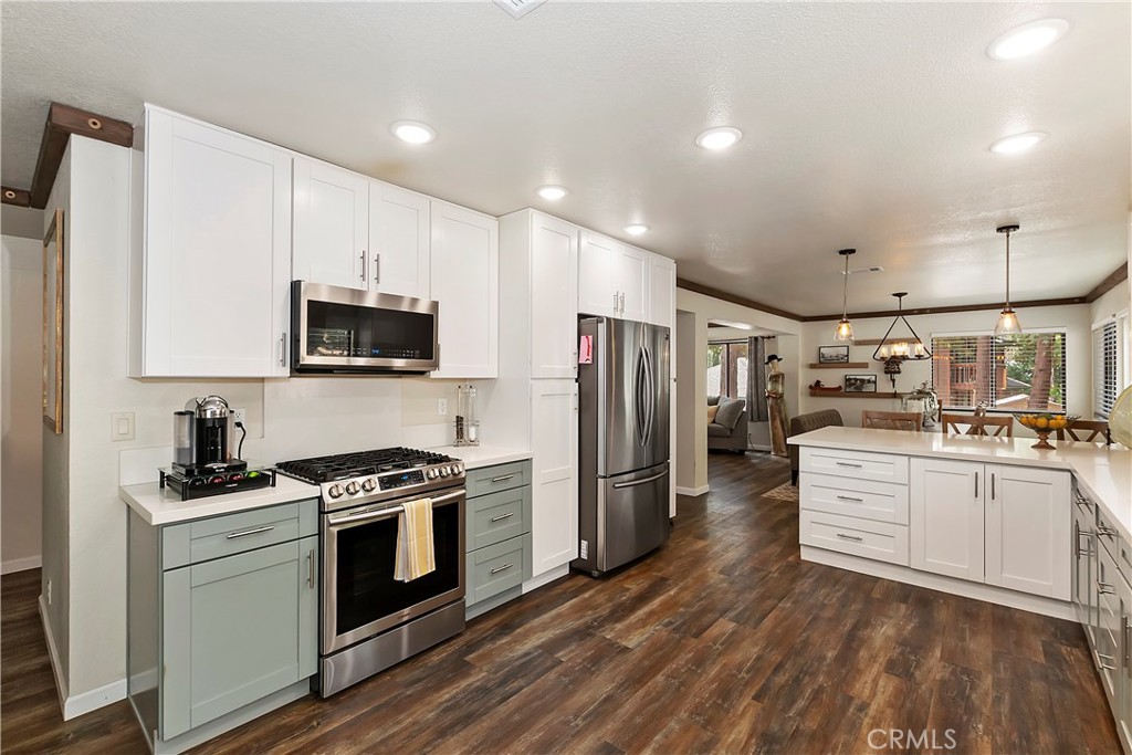 120 Pine Ridge Road Crestline, CA 92325 - Photo 21 of 58 a kitchen with white cabinets and stainless steel appliances