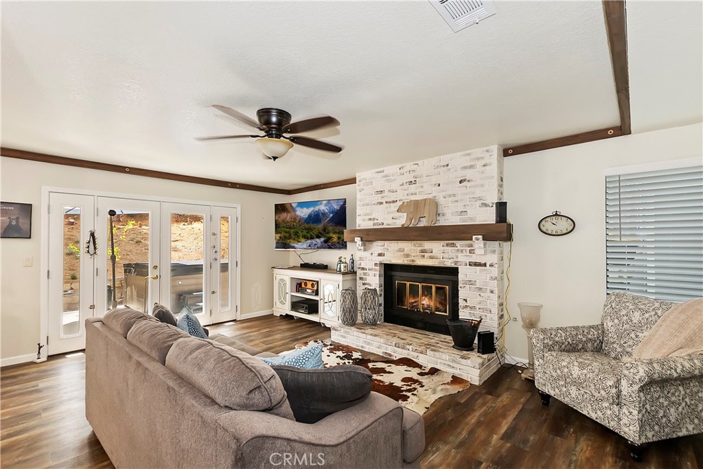 120 Pine Ridge Road Crestline, CA 92325 - Photo 23 of 58 a living room with furniture a fireplace and a large window