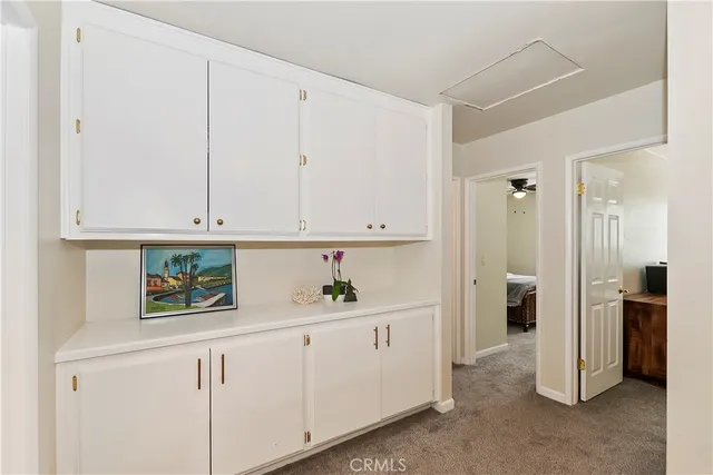 a spacious bedroom with a bed ceiling fan and a large window