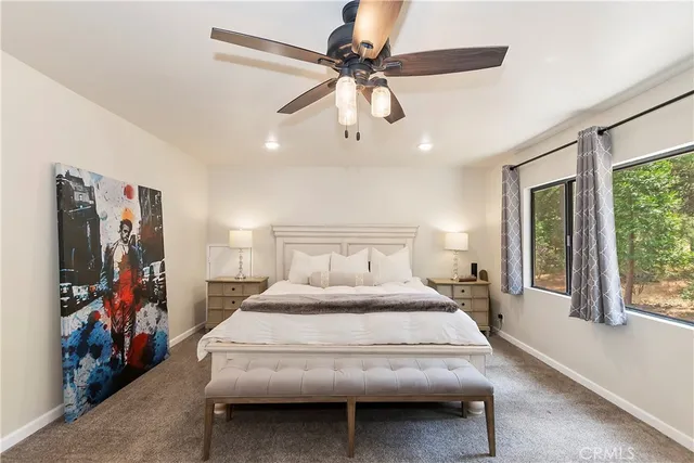a bedroom with a bed and a ceiling fan
