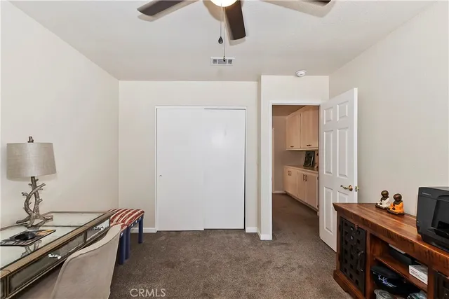 a bathroom with a granite countertop toilet sink and mirror