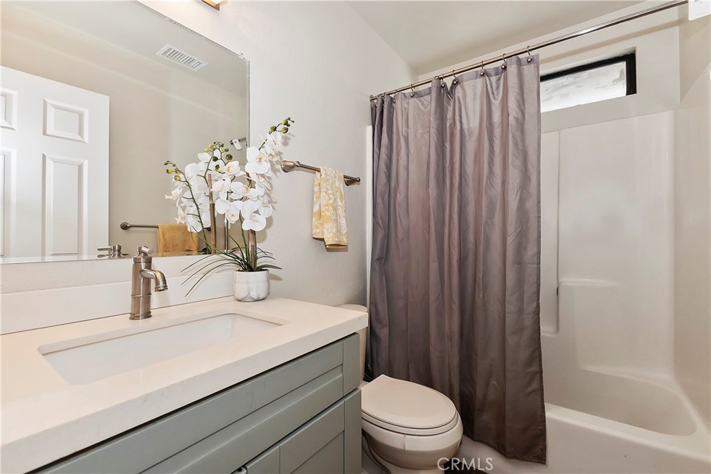 120 Pine Ridge Road Crestline, CA 92325 - Photo 37 of 58 a bathroom with a sink a toilet and shower curtain