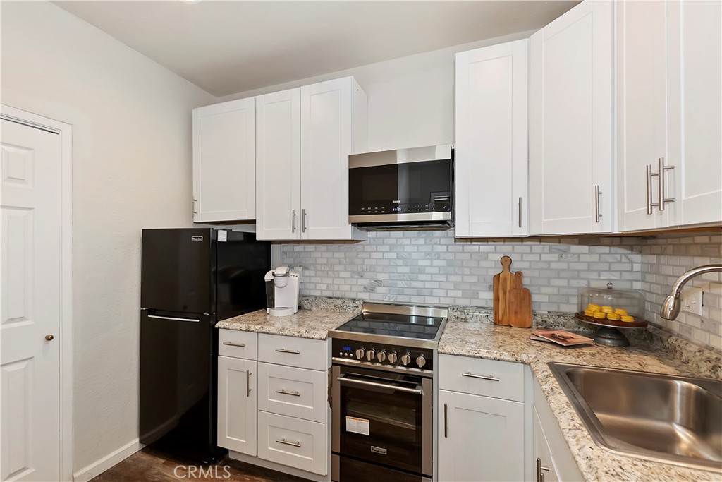 120 Pine Ridge Road Crestline, CA 92325 - Photo 43 of 58 a kitchen with a refrigerator stove and microwave