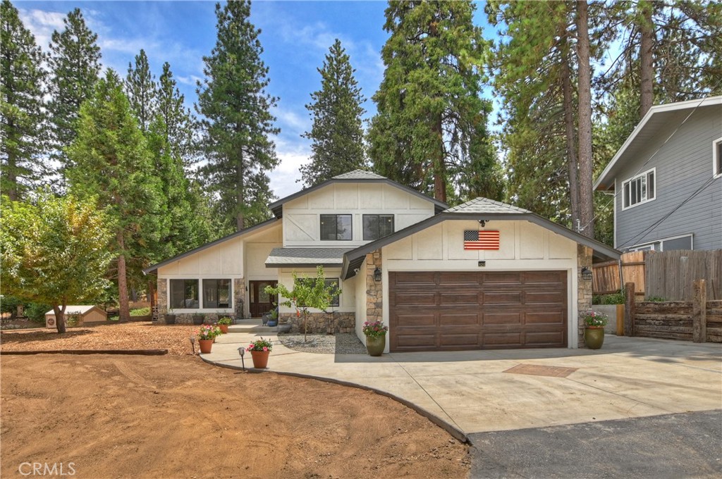 120 Pine Ridge Road Crestline, CA 92325 - Photo 47 of 58 a front view of a house with a yard and garage