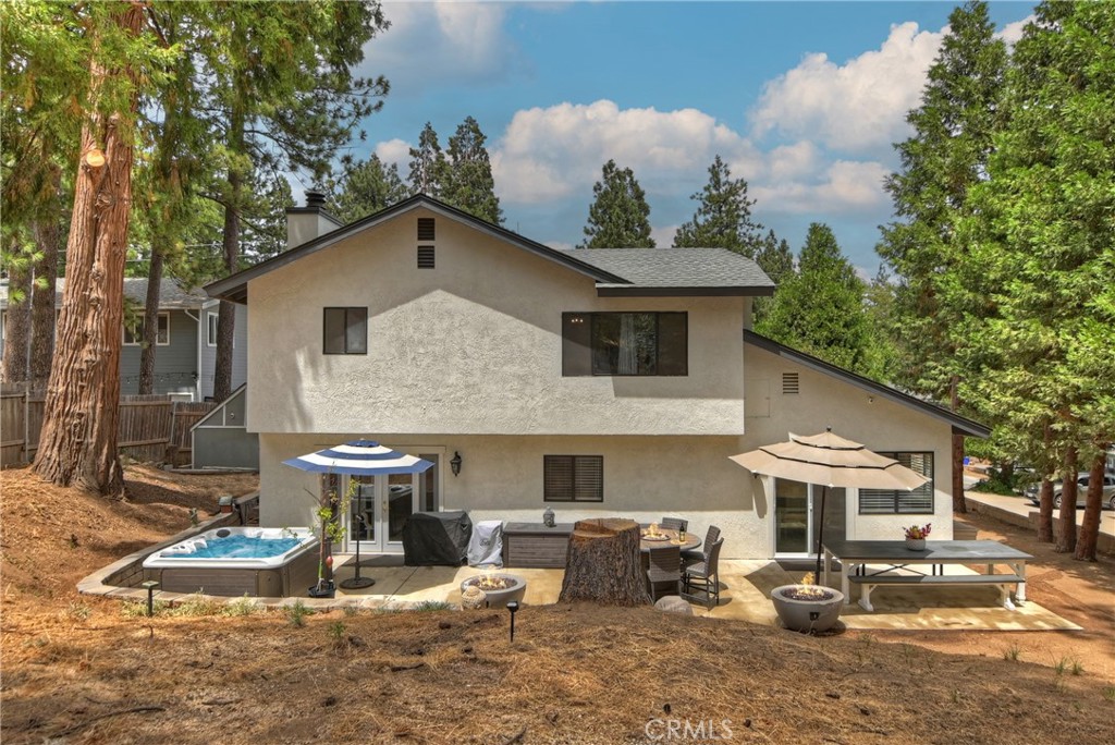 120 Pine Ridge Road Crestline, CA 92325 - Photo 55 of 58 a view of a patio with table and chairs under an umbrella