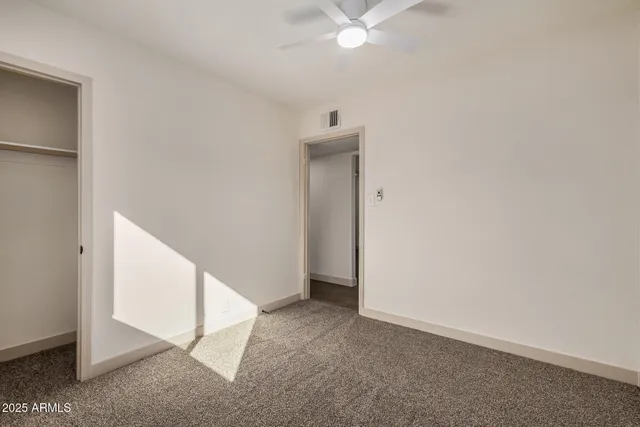 a view of an empty room with a fan