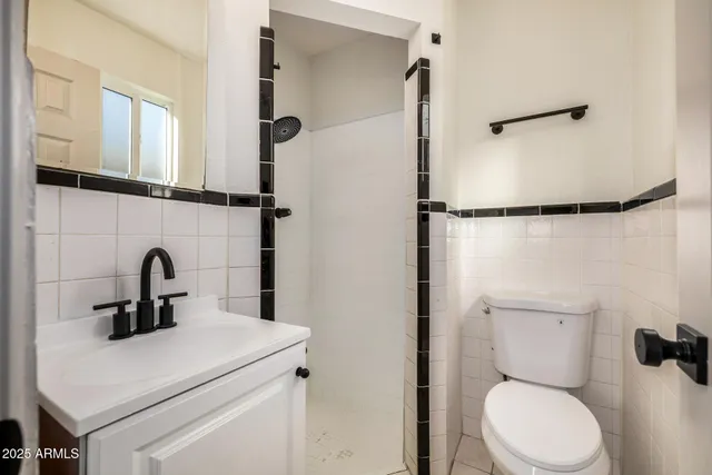 a bathroom with a toilet sink and a shower
