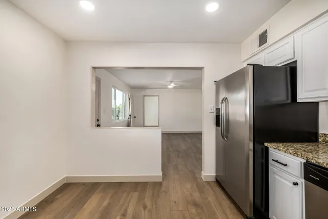 a kitchen with a refrigerator and a sink