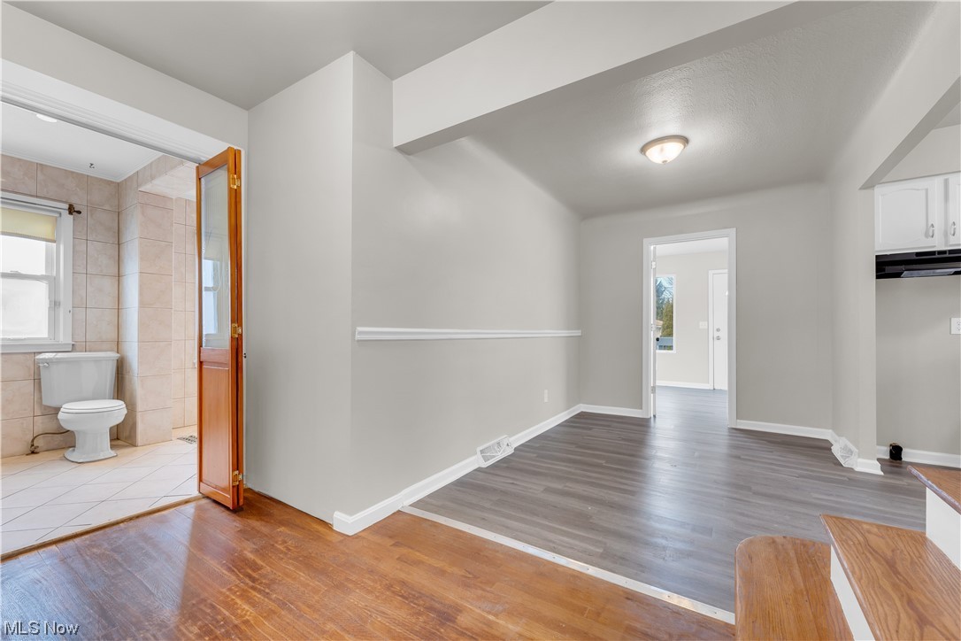 16301 Turney Road Maple Heights, OH 44137 - Photo 31 of 35 Foyer featuring light hardwood / wood-style flooring, tile walls, and plenty of natural light