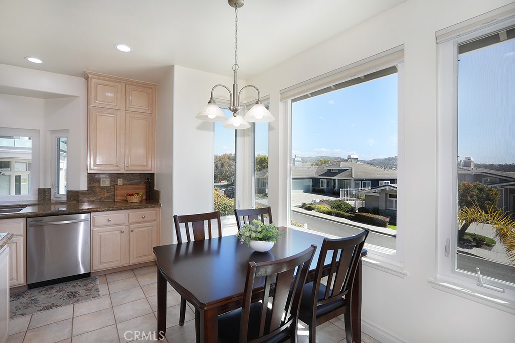 34072 Capistrano By The Sea Dana Point, CA 92629 - Photo 18 of 68 a kitchen with stainless steel appliances granite countertop a dining table chairs and granite counter tops