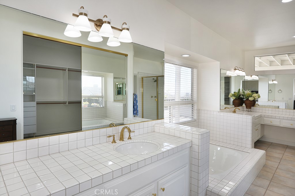 34072 Capistrano By The Sea Dana Point, CA 92629 - Photo 29 of 68 a spacious bathroom with a granite countertop sink a mirror and a shower
