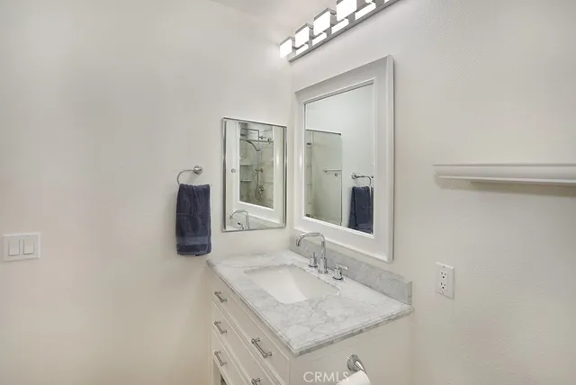 a bathroom with a sink vanity and a mirror