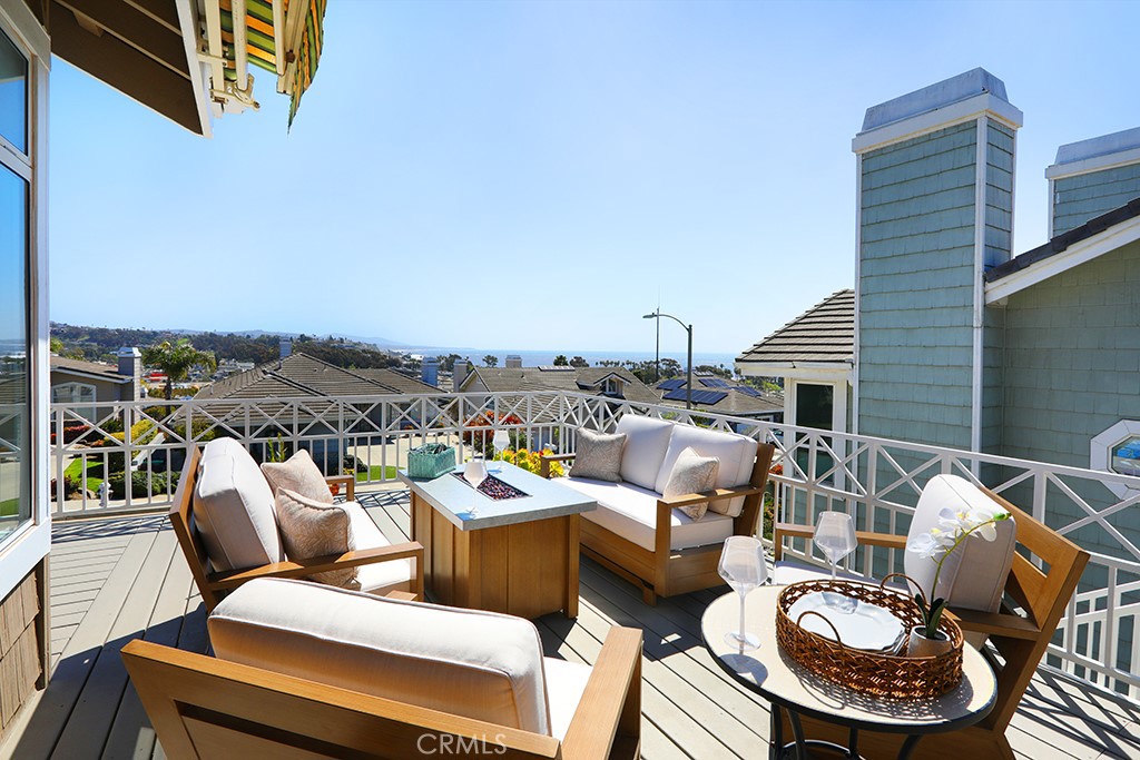 34072 Capistrano By The Sea Dana Point, CA 92629 - Photo 6 of 68 a balcony with furniture and a floor to ceiling window