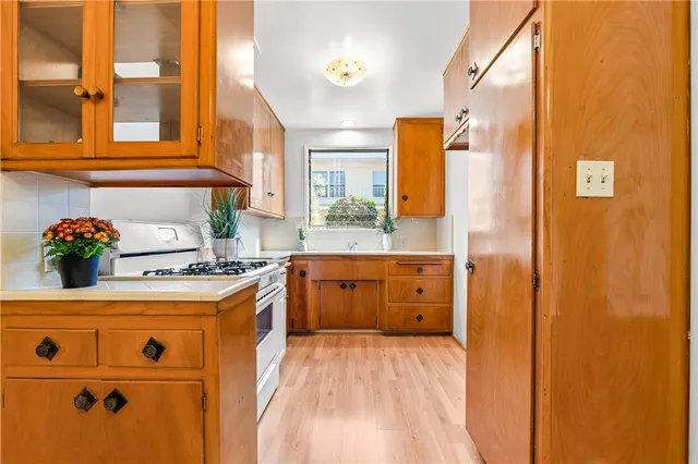 a kitchen with a stove a sink and a refrigerator