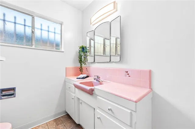 a bathroom with a sink and a mirror