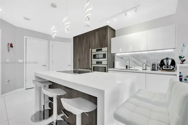 a kitchen with kitchen island a stove and a refrigerator with wooden floor