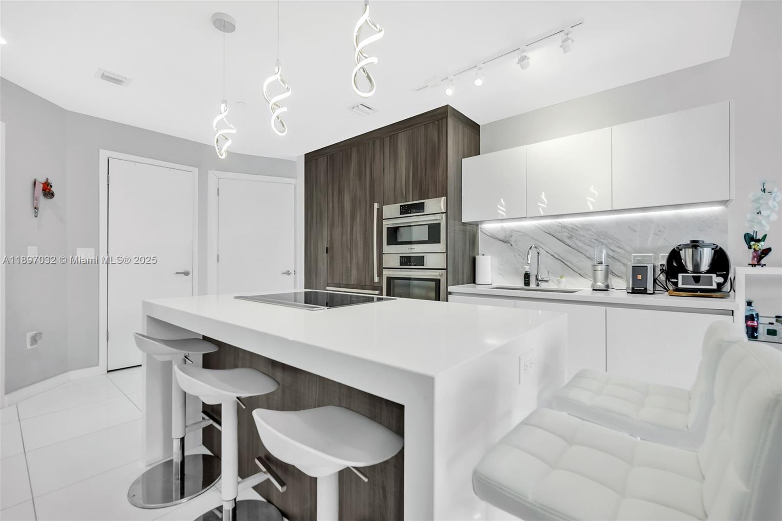 a kitchen with kitchen island a stove and a refrigerator with wooden floor