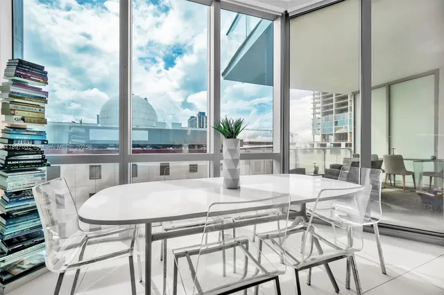 a view of a dining room with furniture large windows and wooden floor