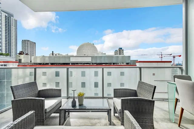a roof deck with table and chairs