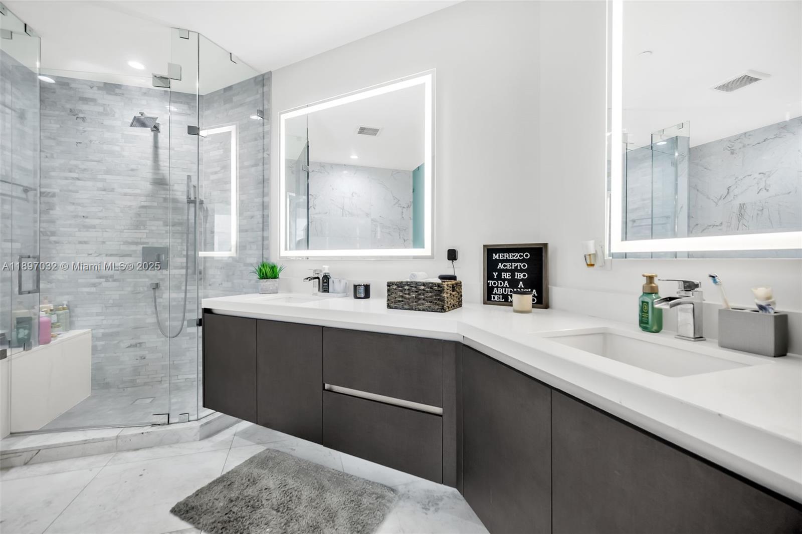851 Northeast 1st Avenue, Unit 806 Miami, FL 33132 - Photo 17 of 51 a bathroom with a sink double vanity granite tub shower and a mirror