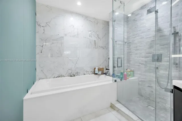 a bathroom with a bathtub and shower