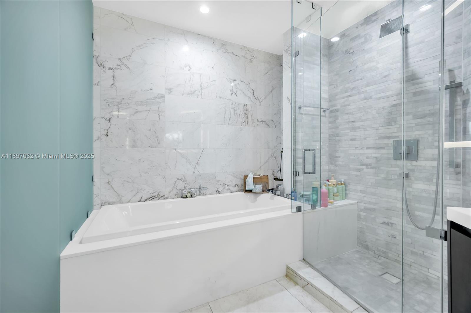 851 Northeast 1st Avenue, Unit 806 Miami, FL 33132 - Photo 18 of 51 a bathroom with a bathtub and shower