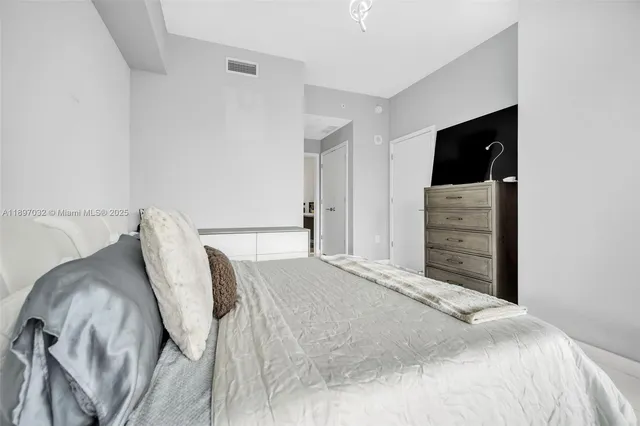 a bedroom with a bed and dresser