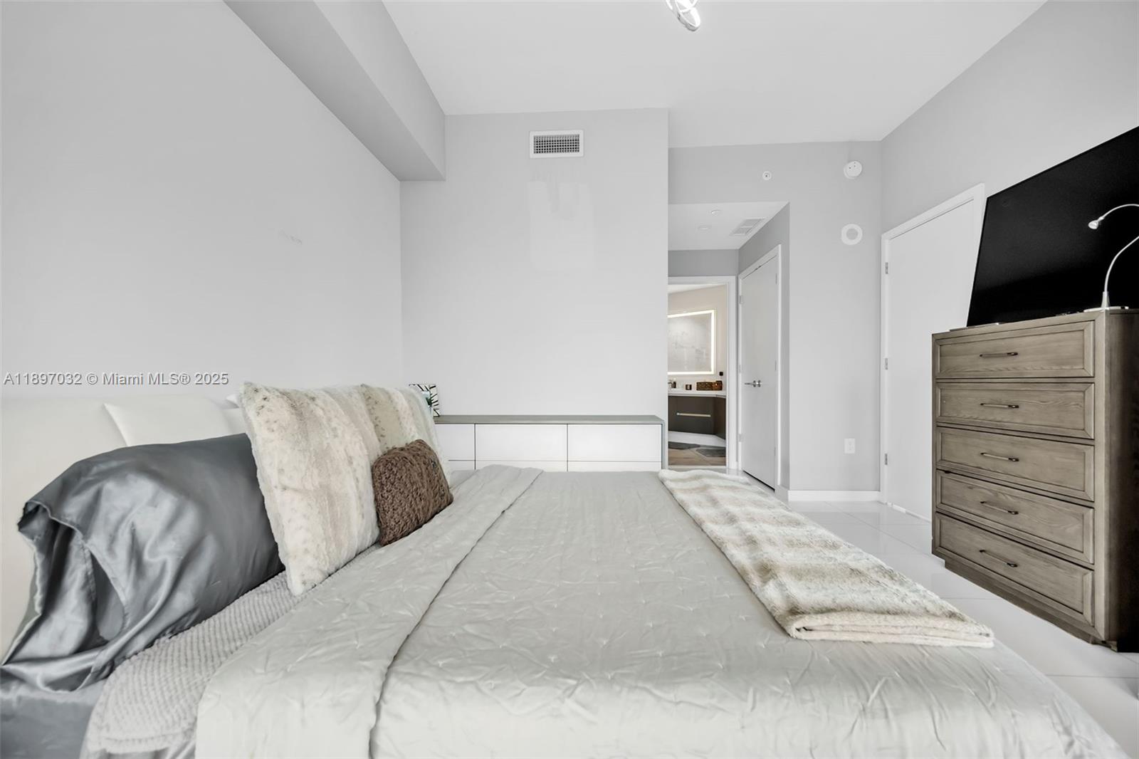 851 Northeast 1st Avenue, Unit 806 Miami, FL 33132 - Photo 21 of 51 a bedroom with a bed and a television