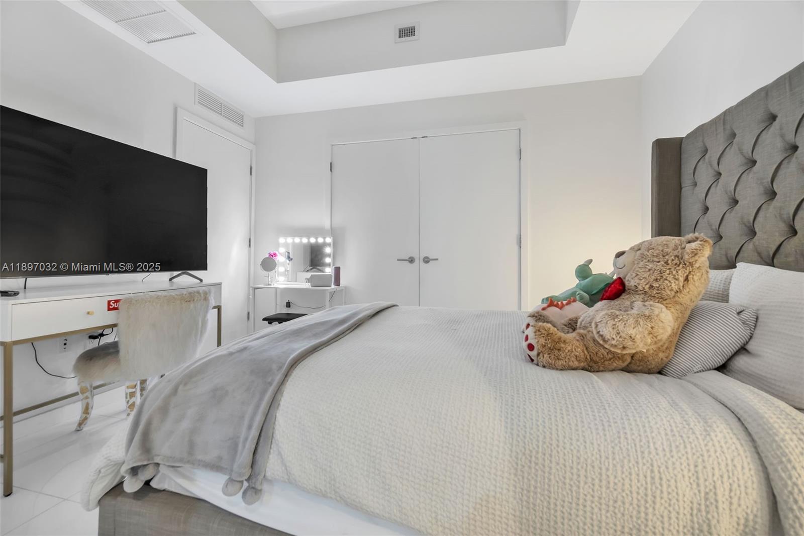 851 Northeast 1st Avenue, Unit 806 Miami, FL 33132 - Photo 24 of 51 a bedroom with a bed and a flat screen tv