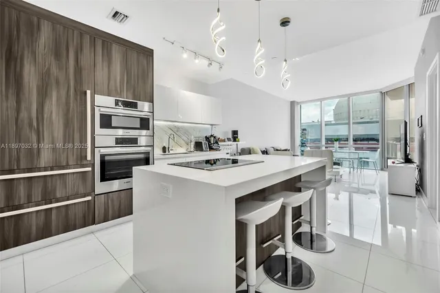 a kitchen with a sink stainless steel appliances and cabinets