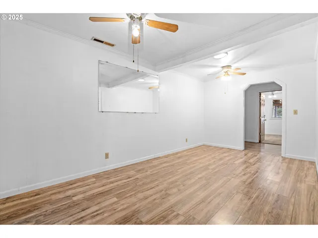 a view of an empty room and wooden floor