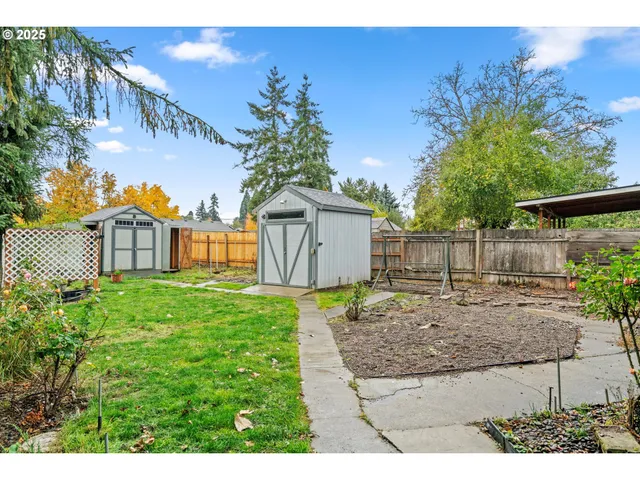 a view of a front of a house with a yard and garage
