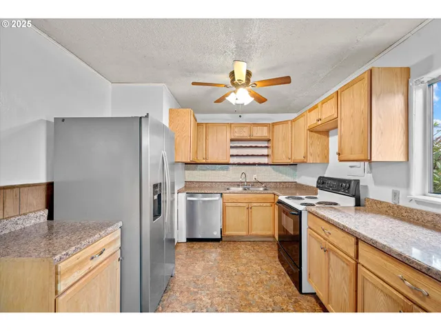 a kitchen with a stove a sink and a refrigerator