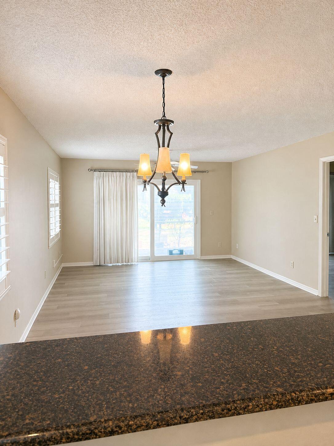 1871 Southwest Palm City Road, Unit G401 Stuart, FL 34994 - Photo 4 of 16 a view of a livingroom with wooden floor and a ceiling fan