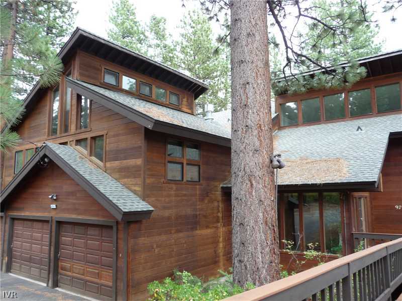 a front view of house with a garden