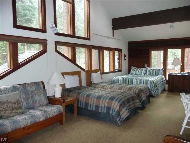 979 Cart Court Incline Village, NV 89451 - Photo 18 of 34 a spacious bedroom with a bed couch and windows