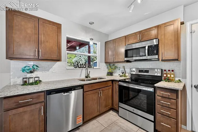 a kitchen with cabinets and chairs