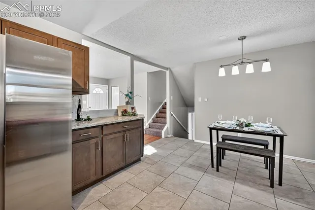 a kitchen with stainless steel appliances granite countertop a refrigerator and a sink
