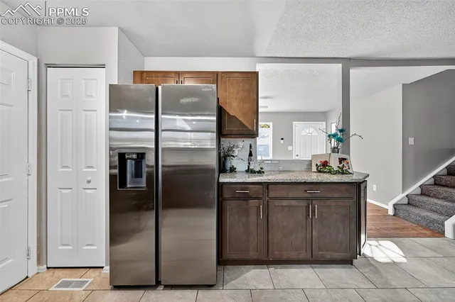 a kitchen with a refrigerator and a stove