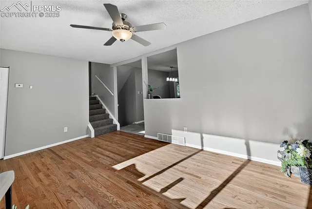 a bedroom with a bed chandelier and a window