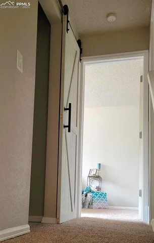 a view of an empty room with fireplace and a window