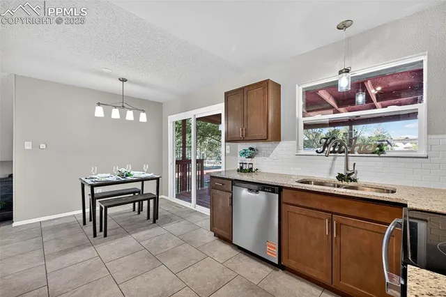 a kitchen with stainless steel appliances a sink stove and cabinets