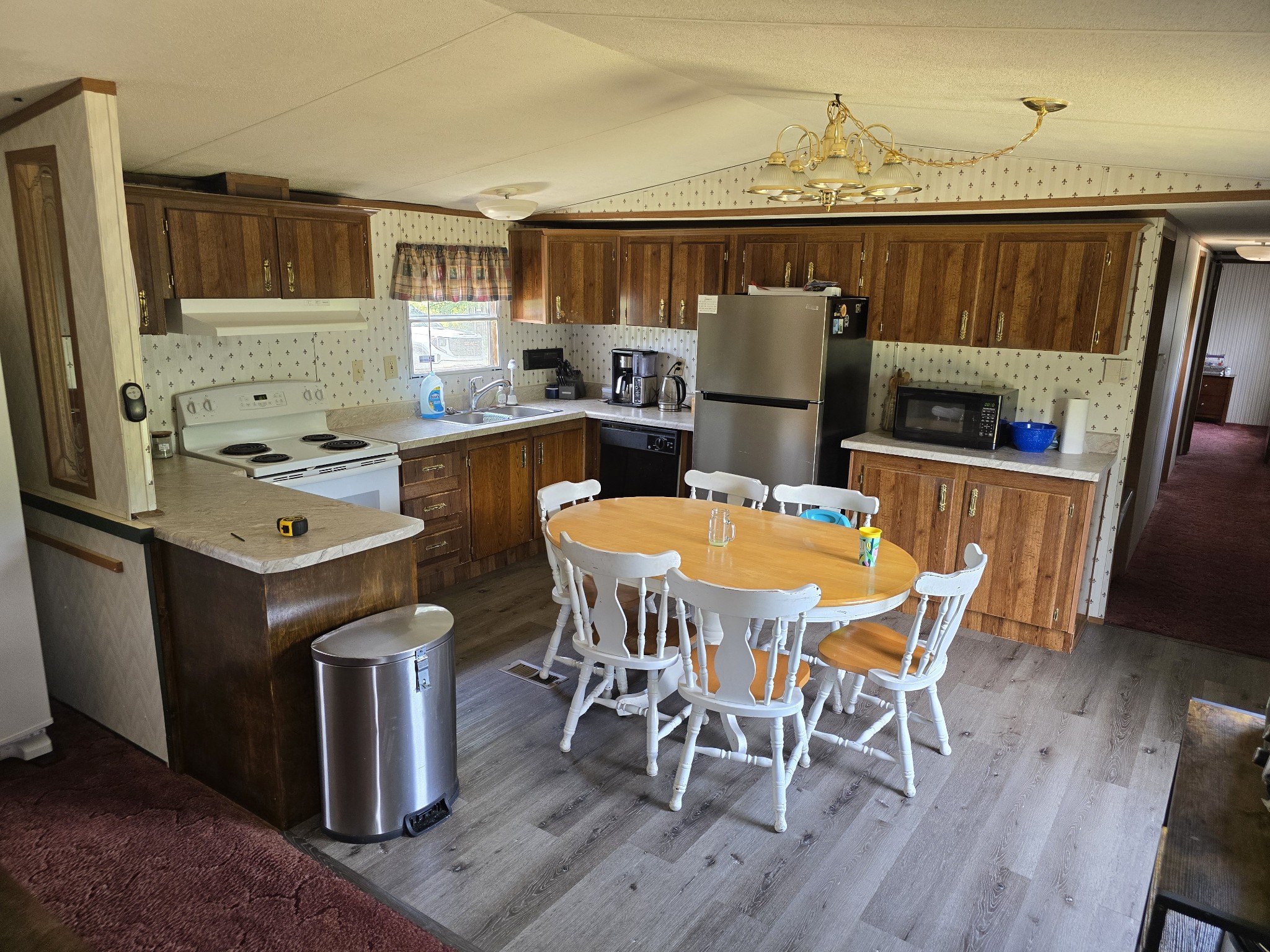 2285 Nancy Green Ridge Road Prospect, TN 38477 - Photo 5 of 17 a kitchen with stainless steel appliances a dining table chairs and wooden floor