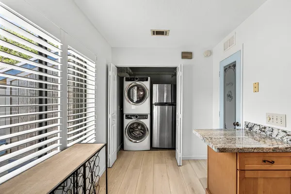 a kitchen with a table chairs refrigerator and cabinets