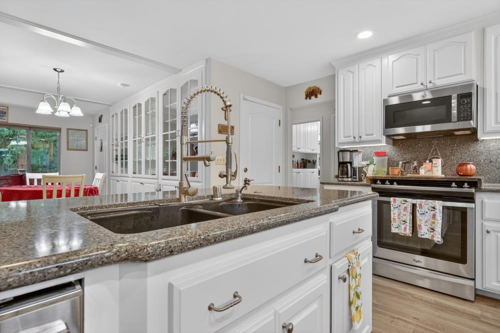 2026 Lily Valley Way West Point, CA 95255 - Photo 21 of 39 a kitchen with granite countertop a sink stainless steel appliances and white cabinets