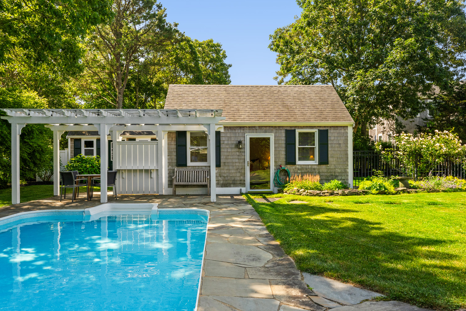 21 Kitts Field Circle Edgartown, MA 02539 - Photo 25 of 34 a front view of a house with a yard table and chairs